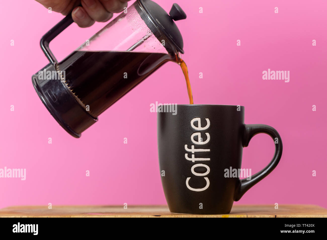 pouring fresh coffee int a mug from a coffee pot Stock Photo Alamy