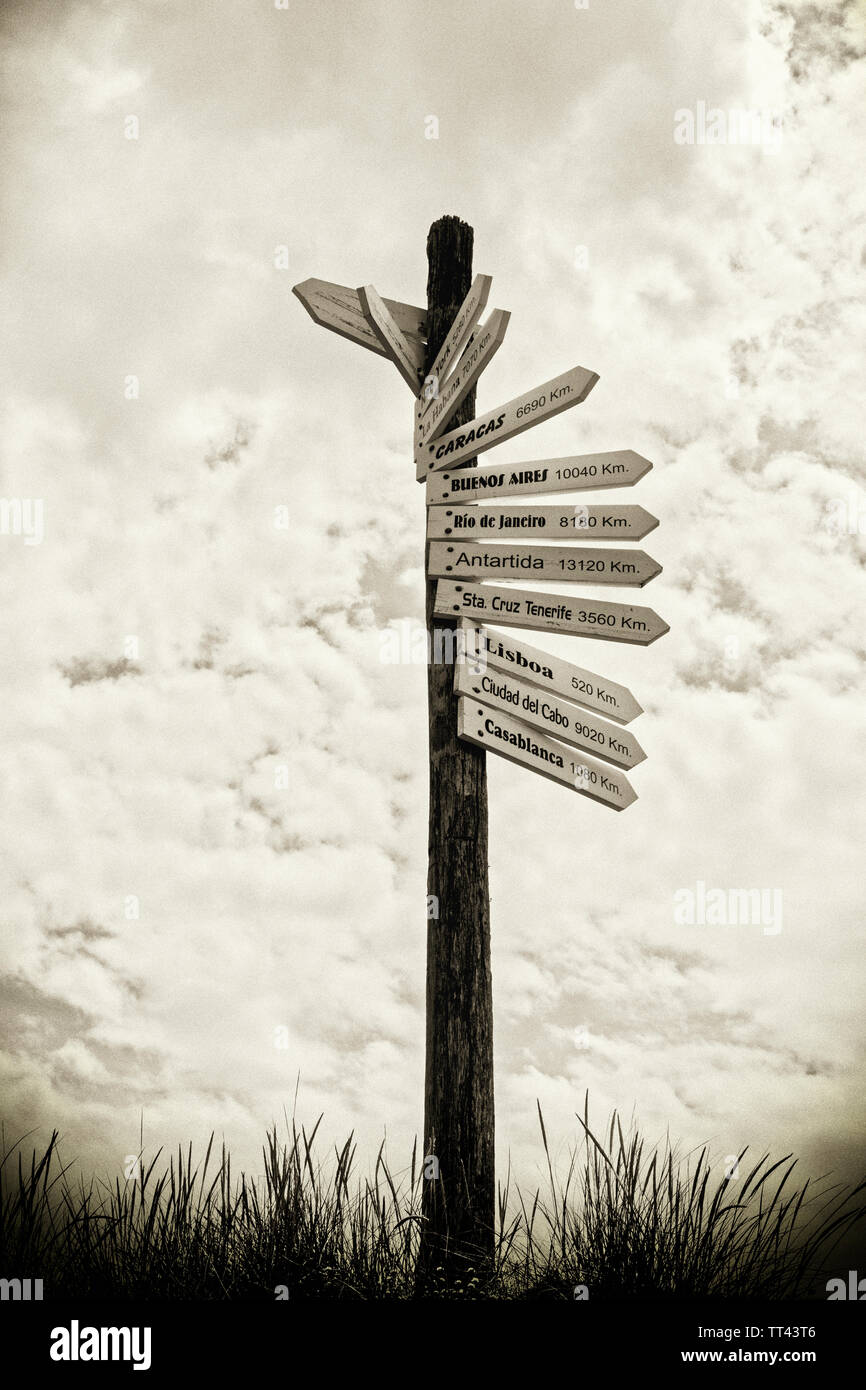 Sign post showing distances in kilkometers to world cities and destinations in the Spanish language.  A Coruna, A Coruna Province, Galicia, Spain. Stock Photo