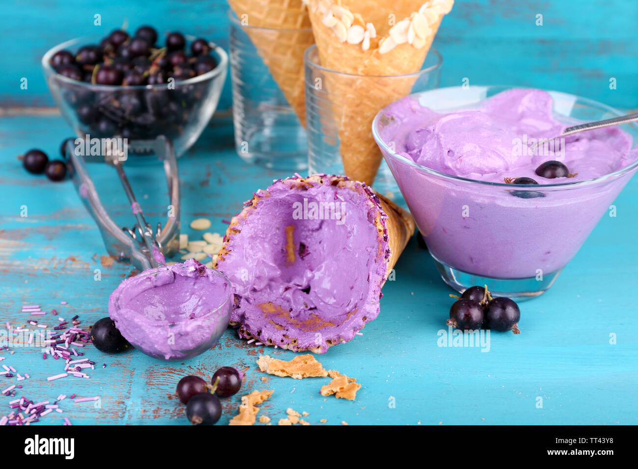 https://c8.alamy.com/comp/TT43Y8/tasty-ice-cream-with-fresh-berries-on-old-blue-wooden-table-TT43Y8.jpg