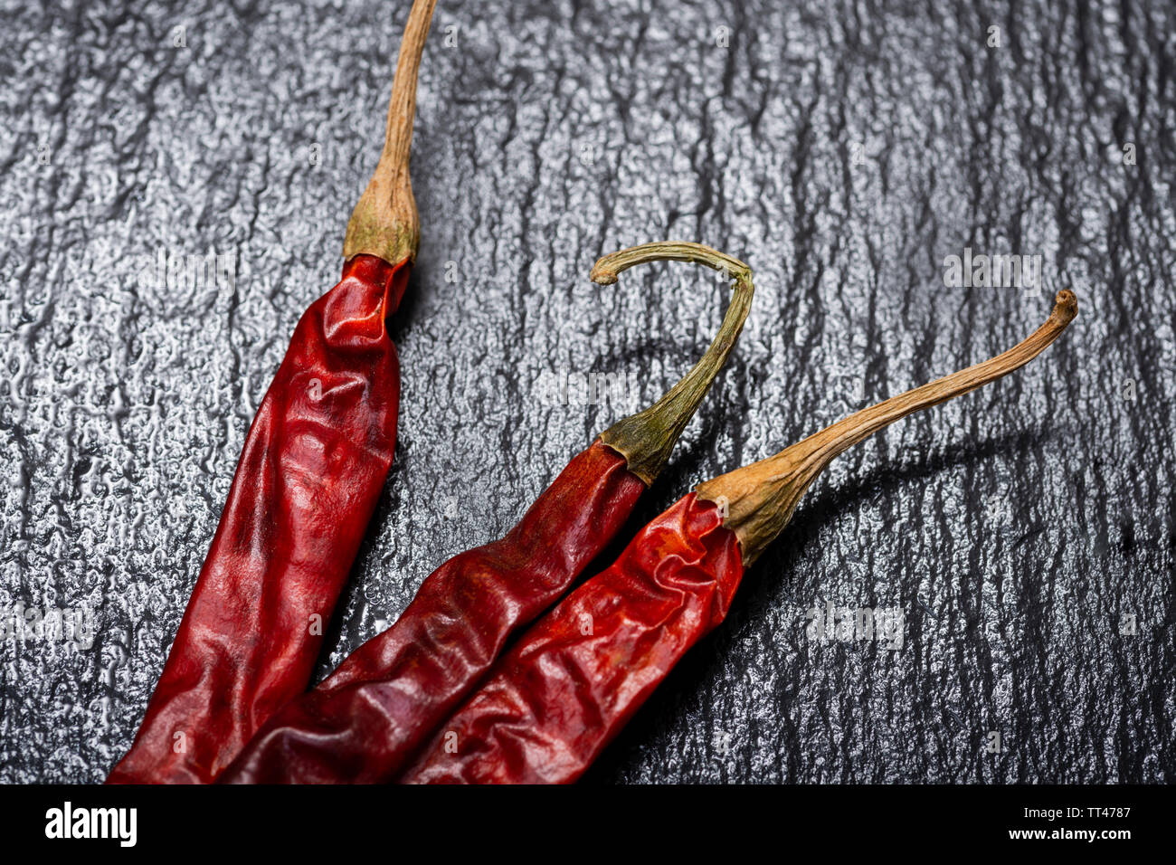 Dried Mexican Red Chile De Arbol Pepper on black natural stone