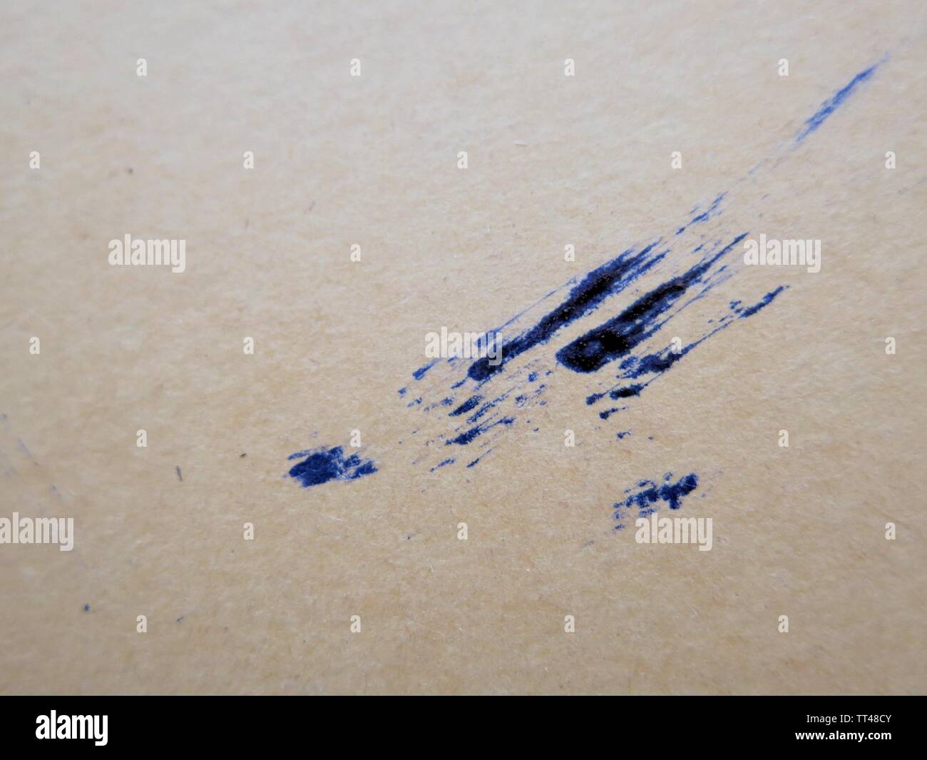 Blue ink smudge on beige paper, abstract Stock Photo Alamy