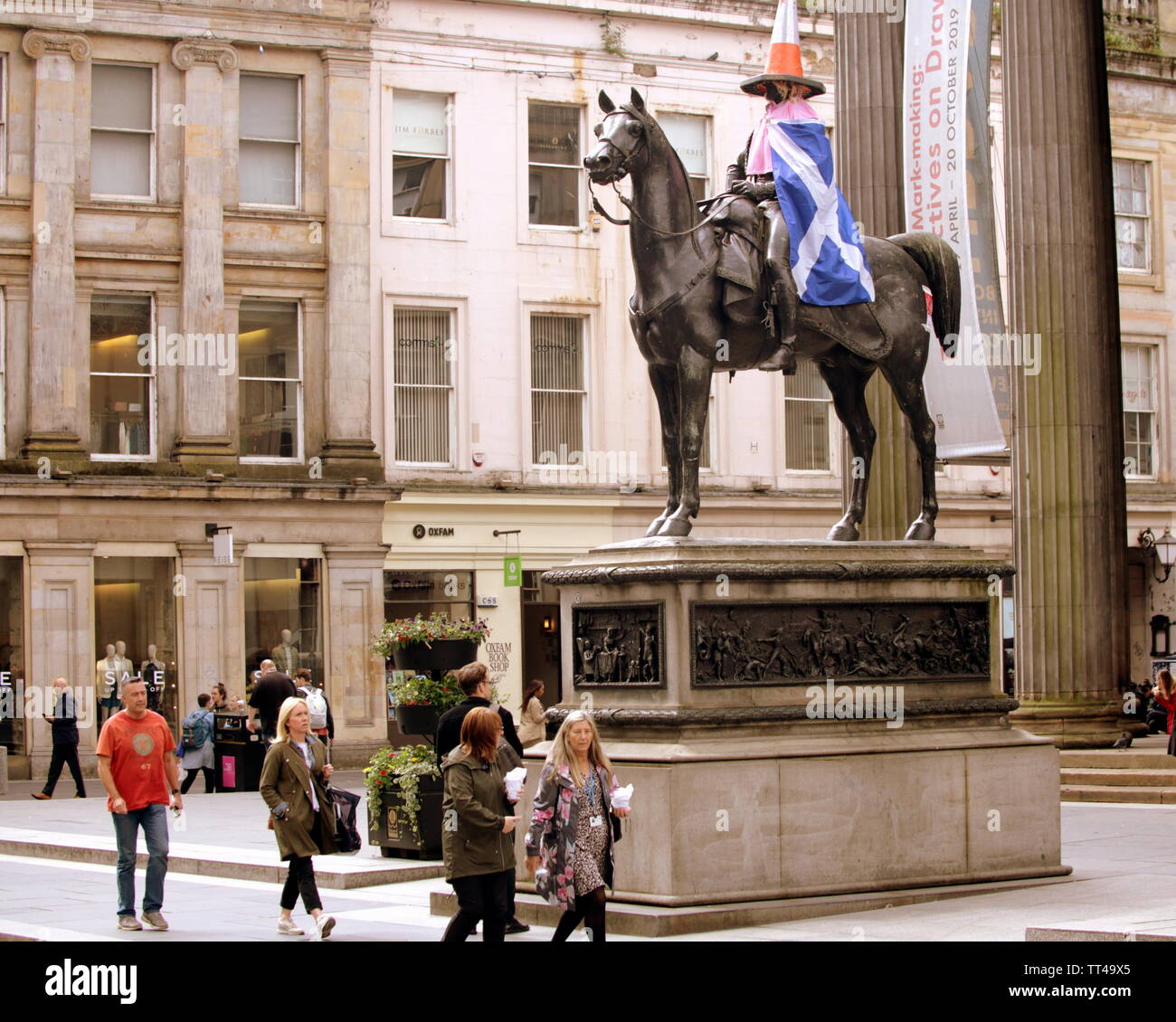 Glasgow, Scotland, UK  14th June, 2019.Woman's world cup Scotland play japan and in  the city with an impromptu makeover of the iconic symbol of the city’s independent nature the cone headed man. The duke of Wellington statue outside the modern art museum, the goma, was given a blonde wig and a pink team top with a placard voicing support for the Scottish woman's team, “C’mon  Scotland” our girls our game”who play England on Sunday. Credit: Gerard Ferry/ Alamy Live News Stock Photo