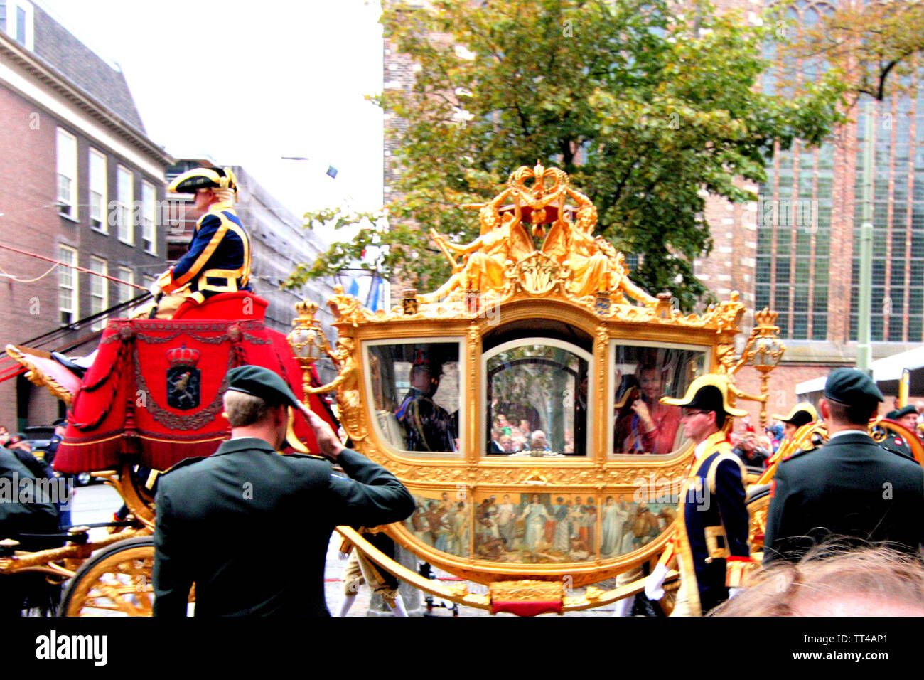 Military officers saluted when Queen Beatrix on the golden carriage was passing by Lange Voorhout Street on Prinsjesdag Parade in Den Haag, Nederland. Stock Photo