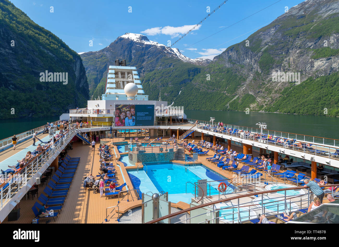 Norwegian Fjords Cruise. Swimming pool on the TUI cruise ship Marella Explorer in the harbour at Geiranger, Gereingerfjord, Norway Stock Photo