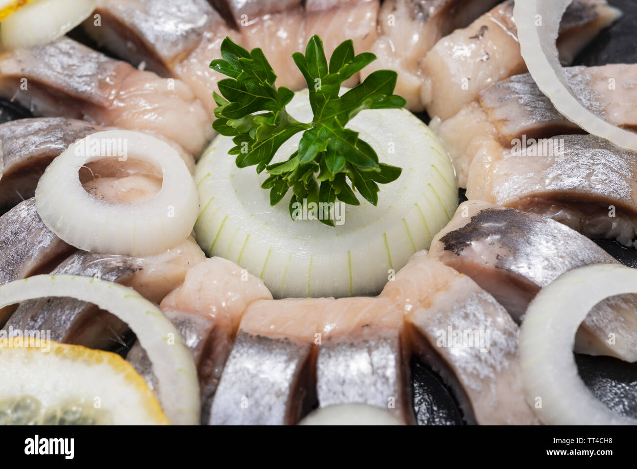 Hollandse Nieuwe Traditional Dutch Food Soused Raw Herring Soaked In Mild Marinade Garnished With Lemon Onion And Parsley On Black Natural Stone Stock Photo Alamy