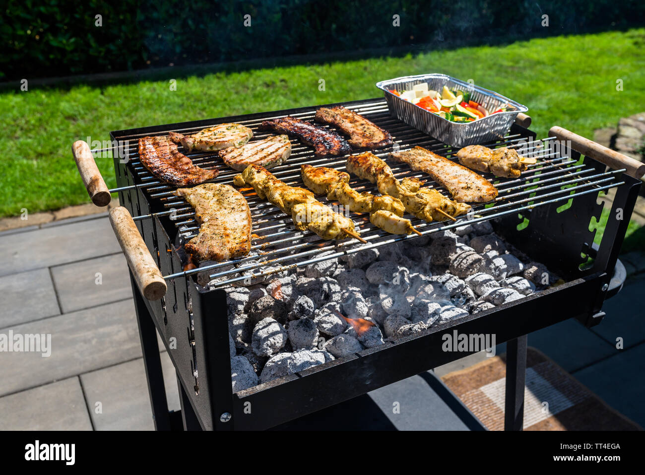 Different types meat fried on the home grill, on a garden on the paving stone Stock Photo Alamy