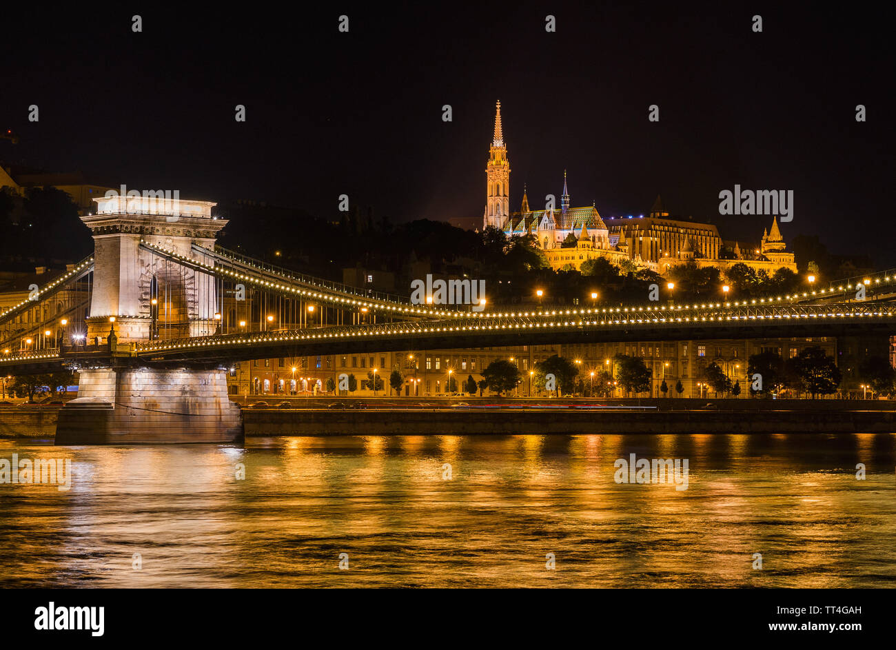 Budapest by night. View of Danube in the center of Budapest with the iconic and monumental Chain Bridge, St Matthias Church and Fisherman's Bastion at Stock Photo