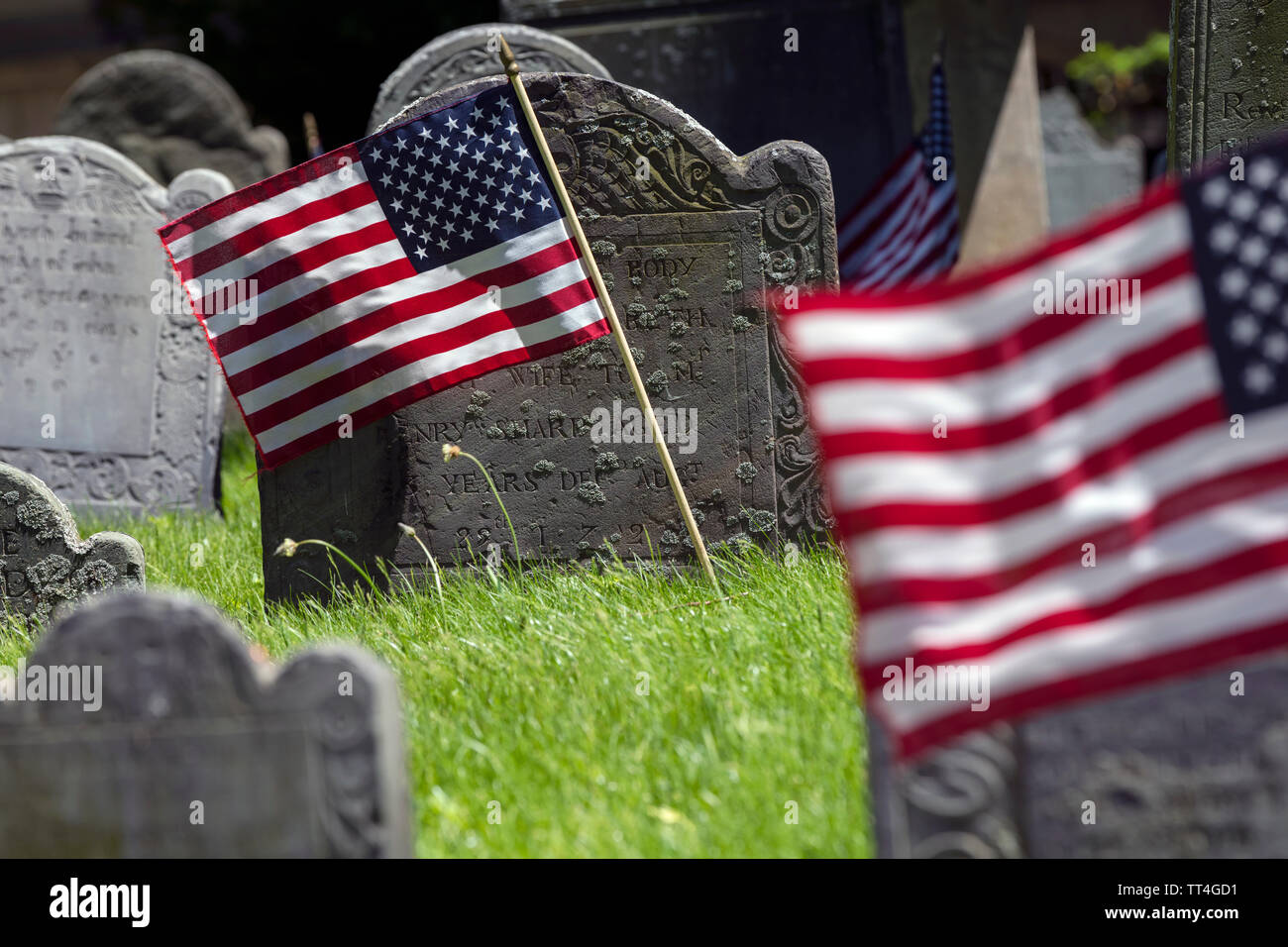 American Flags, old grave stones, Kings Chapel Burial Ground on the Freedom Trail, Boston, Massachusetts, USA Stock Photo