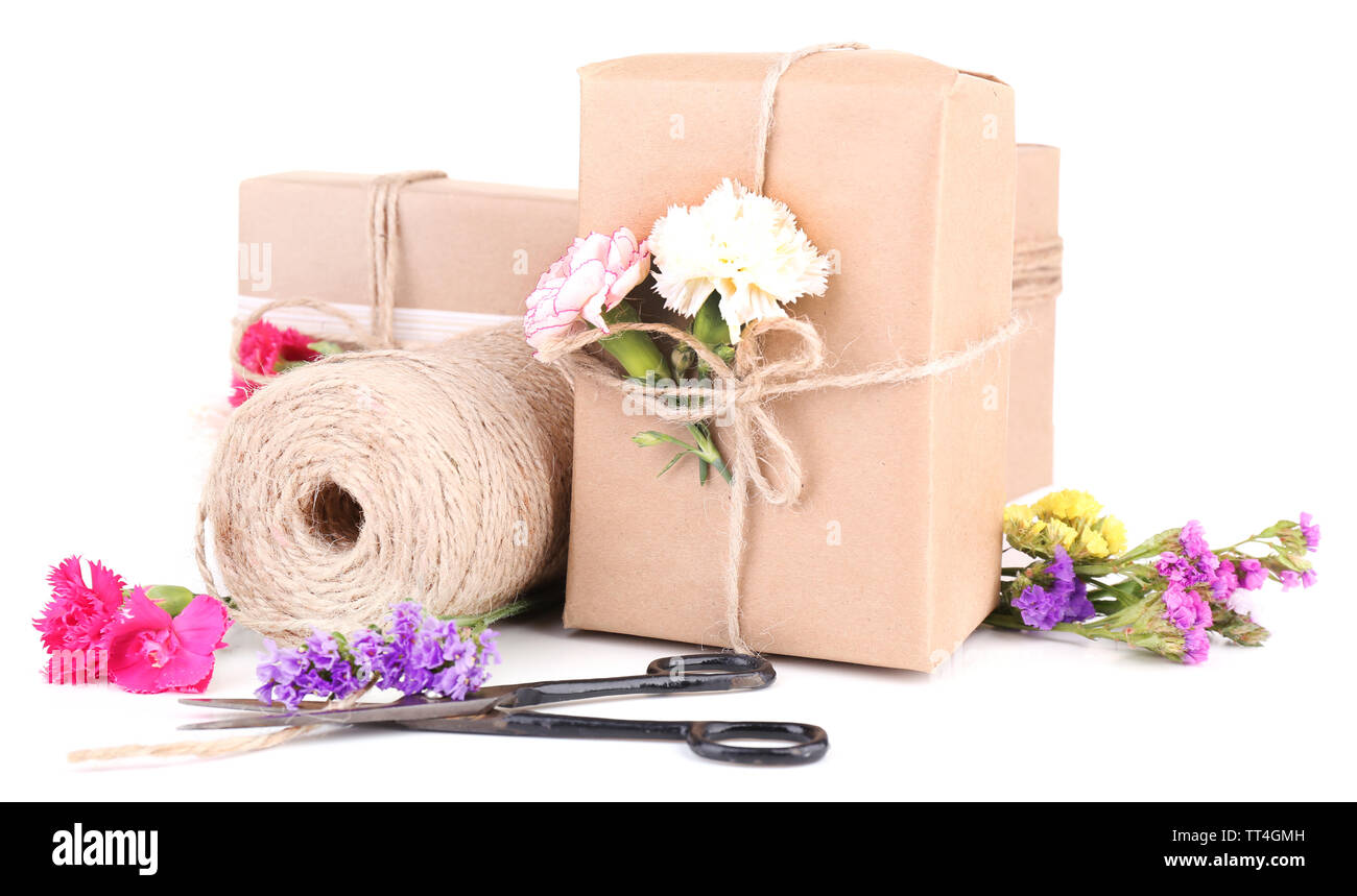 Beautiful gifts with flowers and decorative rope, isolated on white ...