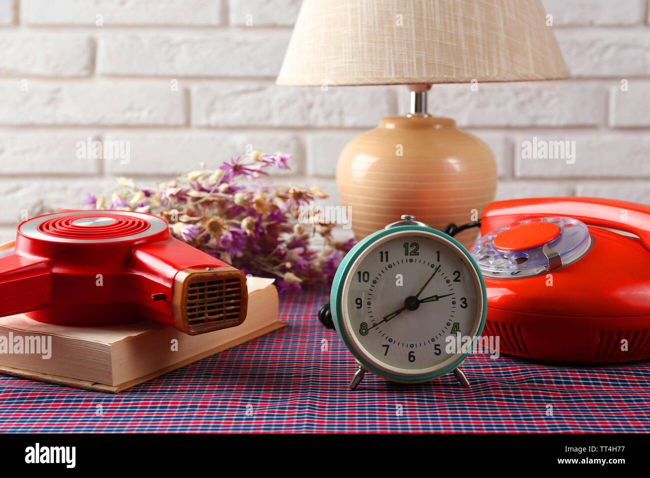 Retro things on table-hairdryer, clock, phone, book Stock Photo