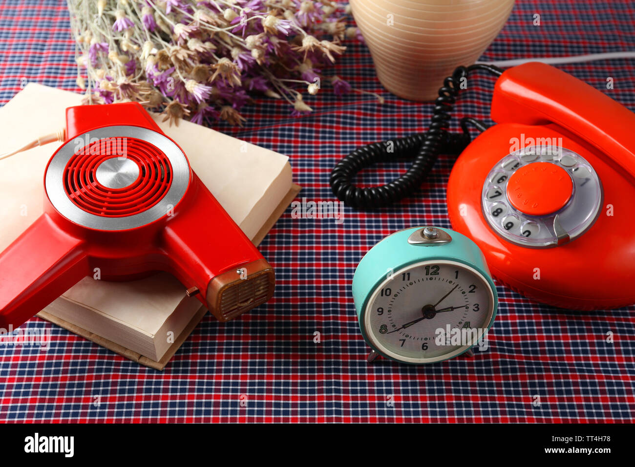 Retro things on table-hairdryer, clock, phone, book Stock Photo