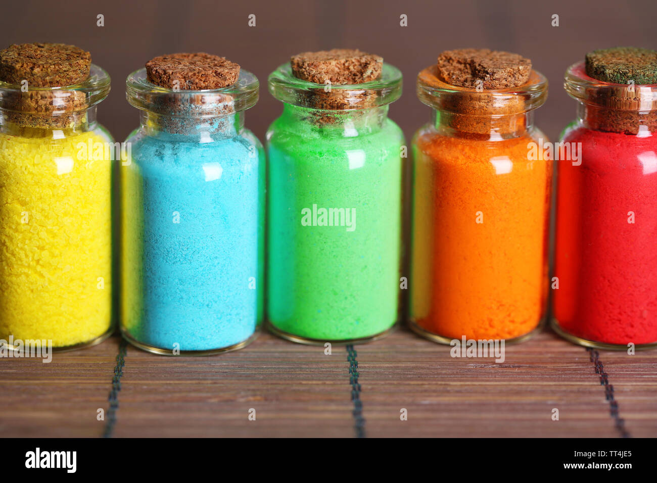 Bottles with colorful dry pigments on bamboo mat background Stock Photo ...