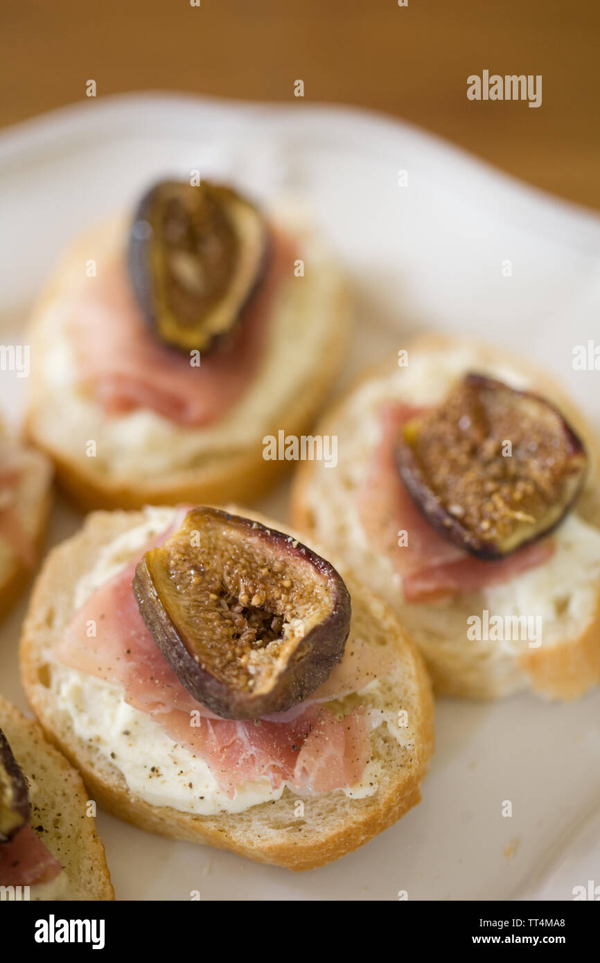 baked fig, prosciutto and mascarpone topped crostini Stock Photo Alamy