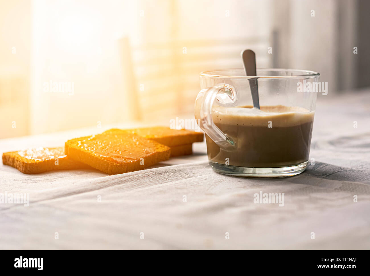 group of biscuits with jam spread with a cup of cappuccino on a table with the decorated tablecloth. Morning breakfast. Healthy food and lifestyle Stock Photo