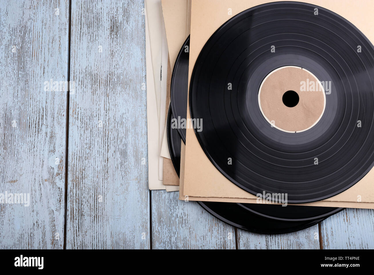 Vinyl records records and paper covers on wooden background Stock Photo ...