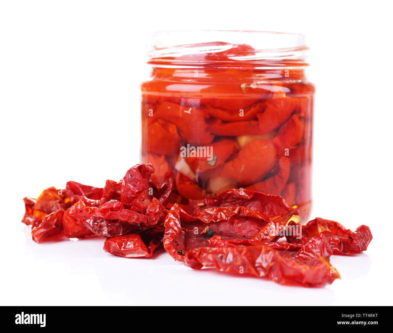 Sun dried tomatoes in glass jar isolated on white Stock Photo