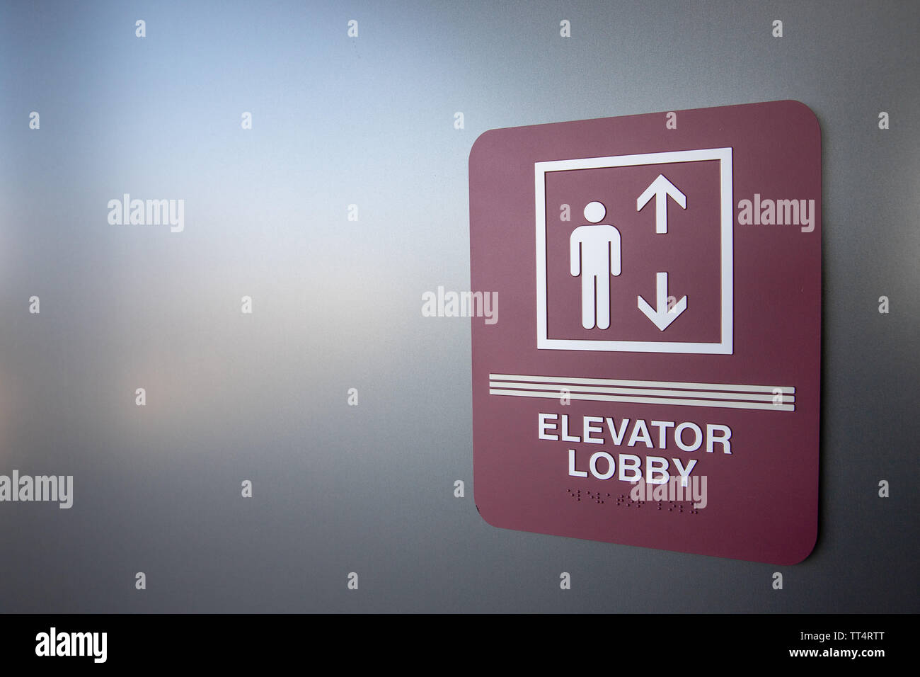 sign in building indicating where the elevator is Stock Photo