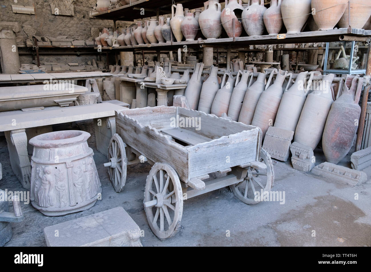 Cart or wagon, amphora and other finds from archaeological excavation of the ancient Roman town of Pompeii in Campania near Naples in Southern Italy Stock Photo