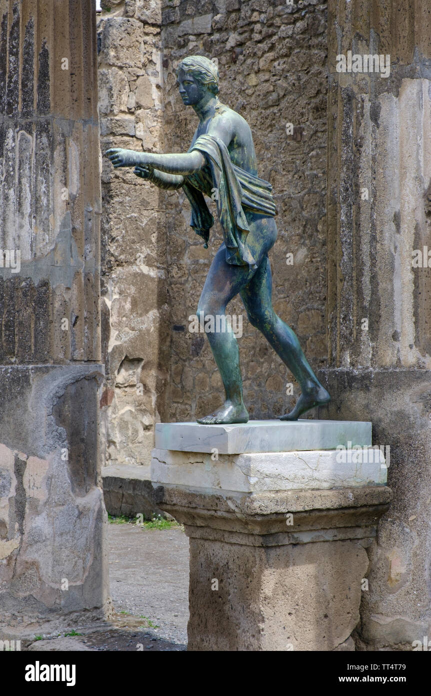 Modern statue among the ruins and archaeological excavations of the ancient Roman town of Pompeii in Campania near Naples in Southern Italy Stock Photo