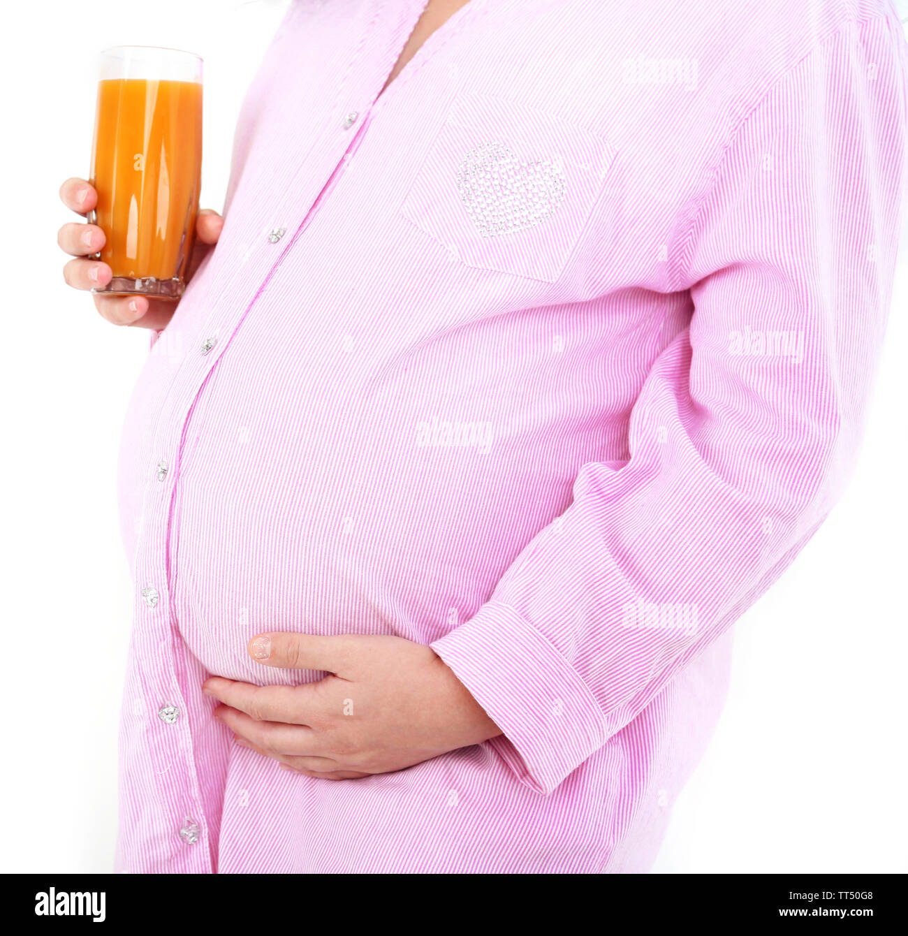 Young pregnant woman holding glass of juice on light background Stock ...