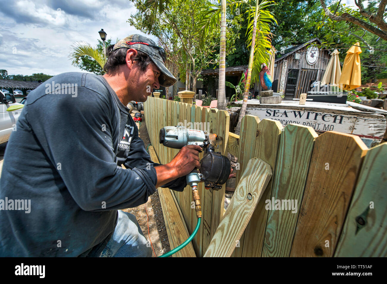 UNITED STATES - July 18, 2016: Axel Villagran puts the finial touches on a new wall going up at the Brew Kitchen 'beach' outdoor area in downtown Lees Stock Photo