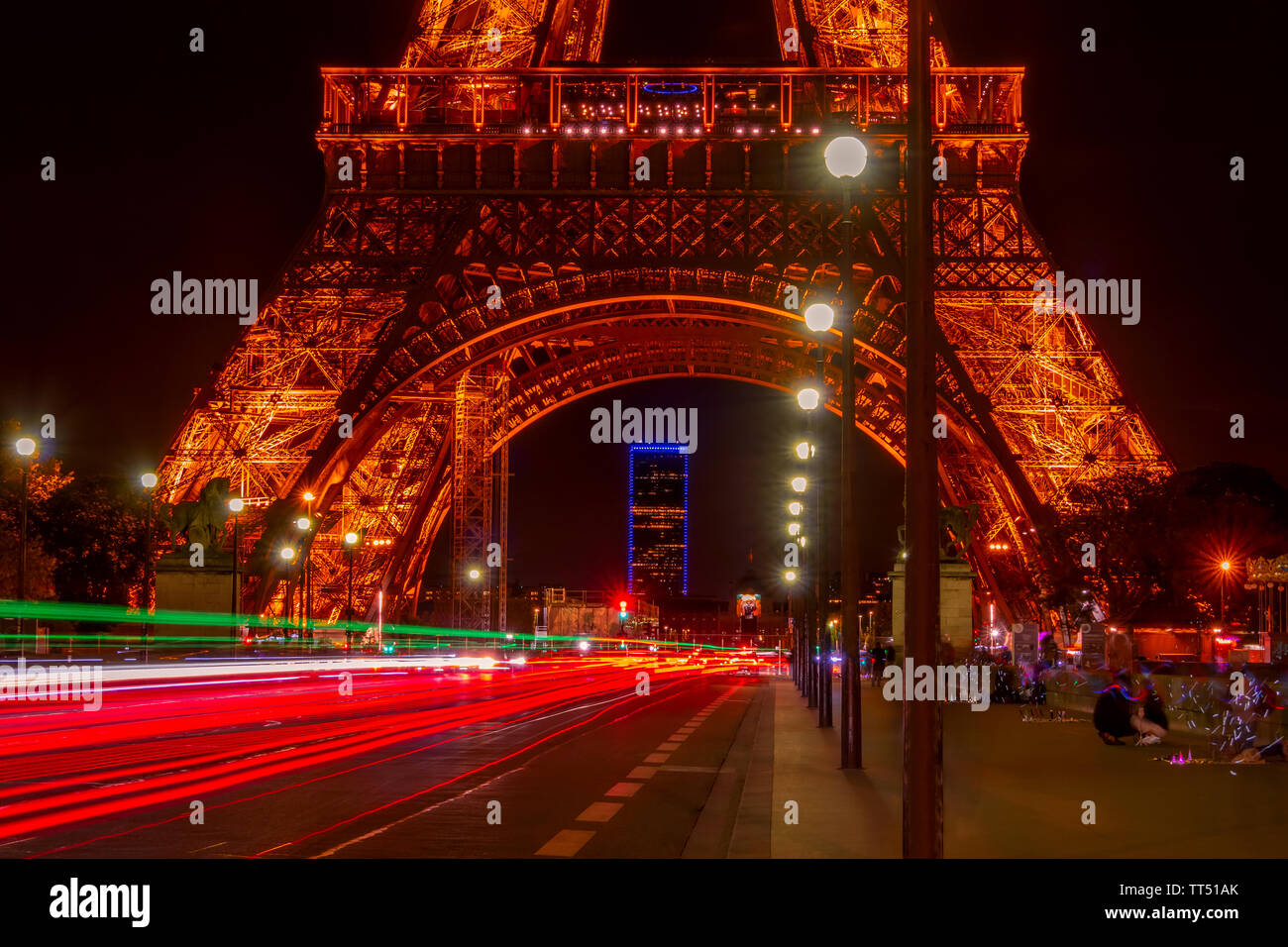 France. Paris. Summer night near the Eiffel Tower. Car Traffic on the Jena Bridge Stock Photo