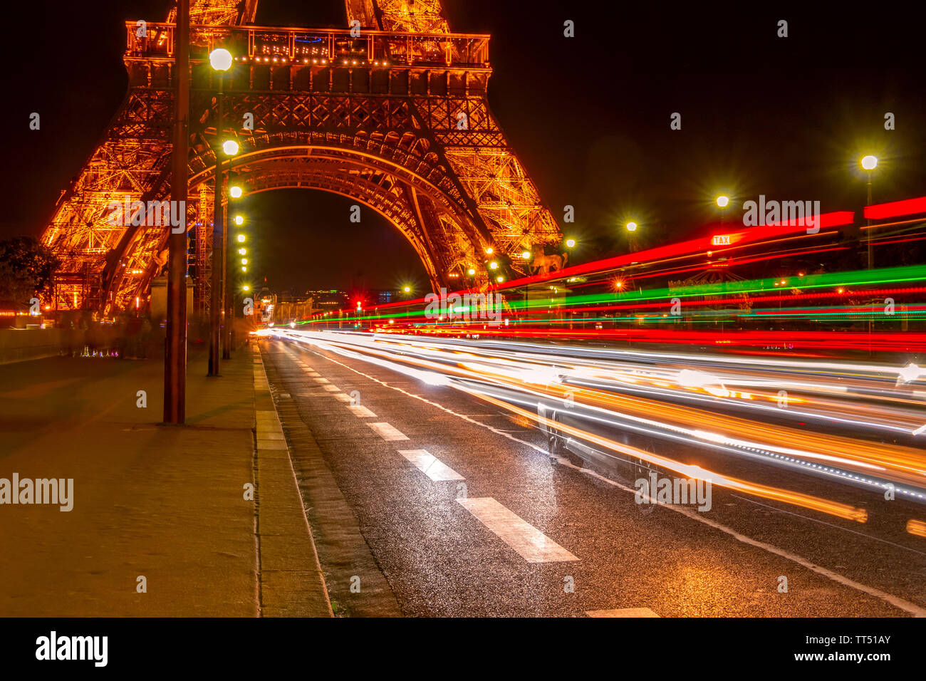 France. Paris. Summer near the Eiffel Tower. Night Car Traffic on the Jena Bridge Stock Photo