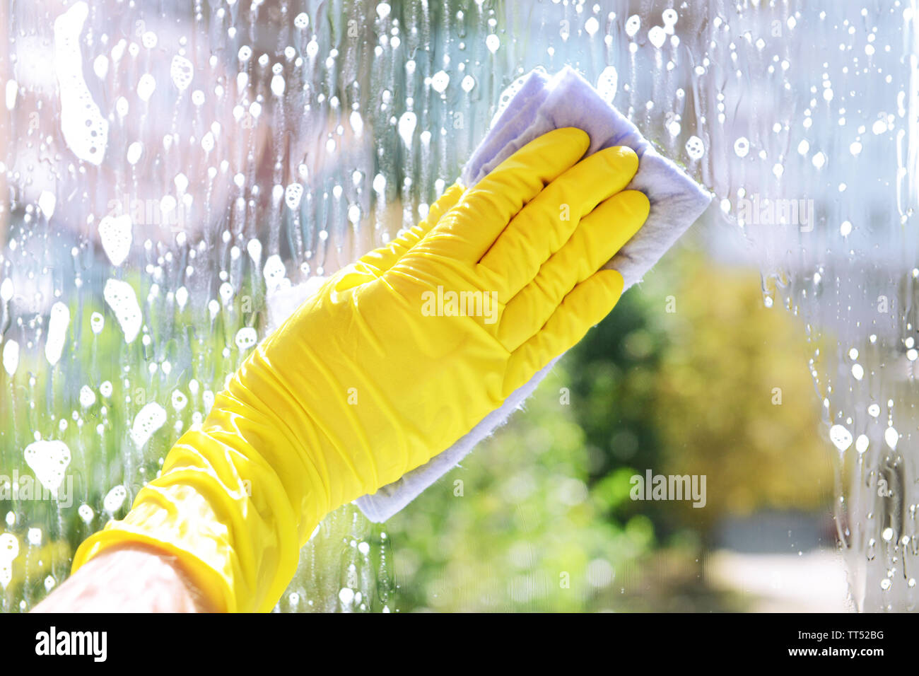 Cleaning windows with special rag Stock Photo - Alamy