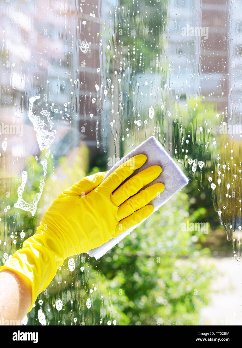 Cleaning windows with special rag Stock Photo - Alamy