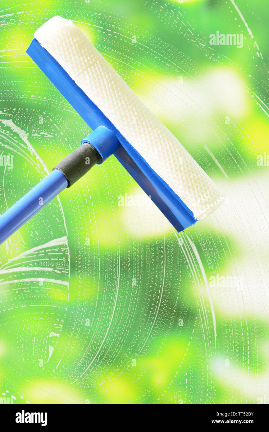 Cleaning windows with special squeegee Stock Photo Alamy