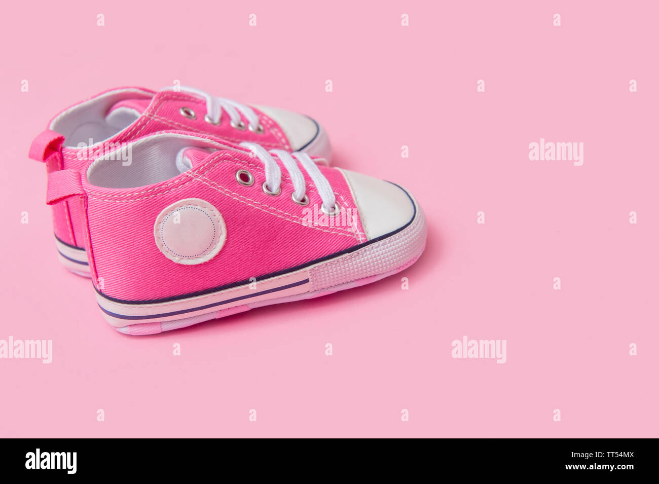 Cute pink baby girl sneakers close up on pink background Stock Photo ...