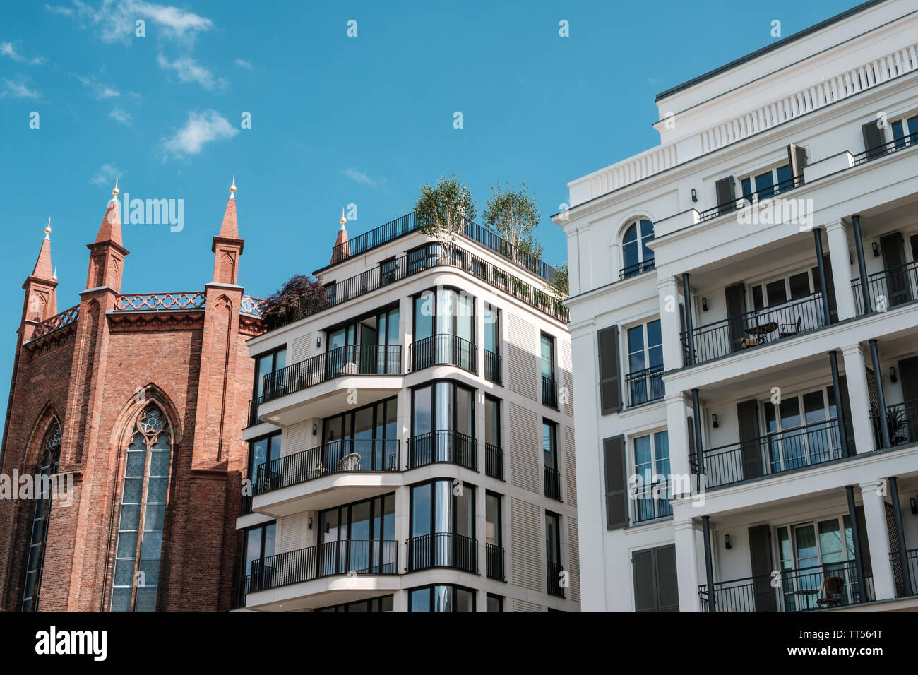 modern architecture apartment buildings and old church real estate in