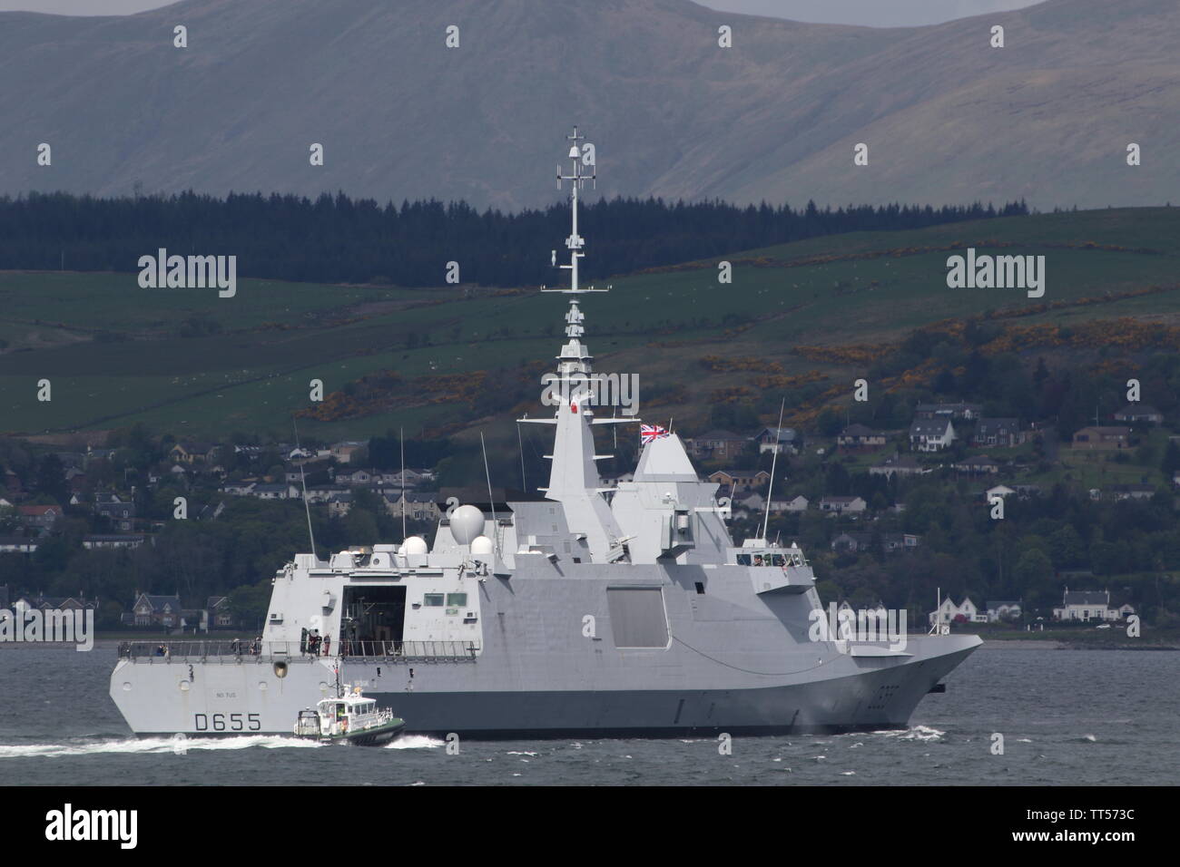 The French Navy frigate FS Bretagne (D655), with the Admiralty pilot boat SD Clyde Racer escorting, on her arrival for Exercise Formidable Shield 2019 Stock Photo