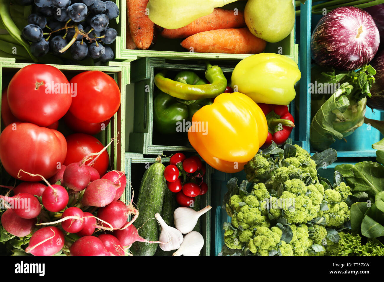 Fresh organic vegetables and fruits in wooden boxes, close up Stock ...