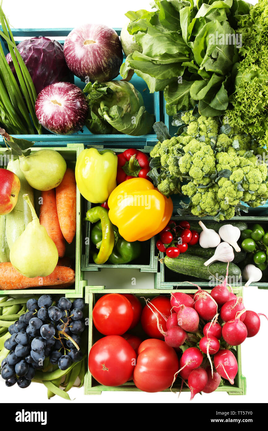 Fresh organic vegetables and fruits in wooden boxes, close up Stock ...