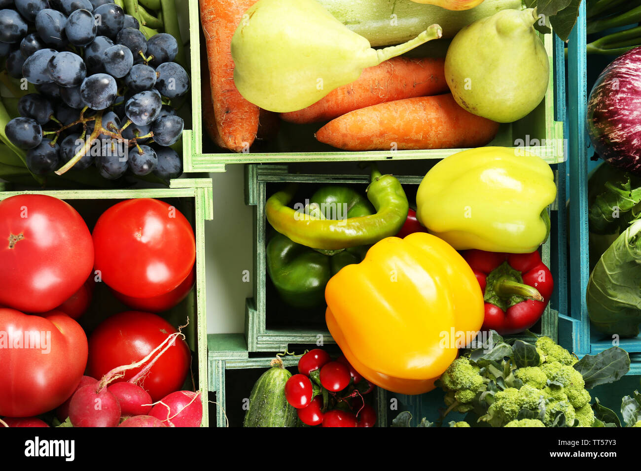 Fresh organic vegetables and fruits in wooden boxes, close up Stock ...