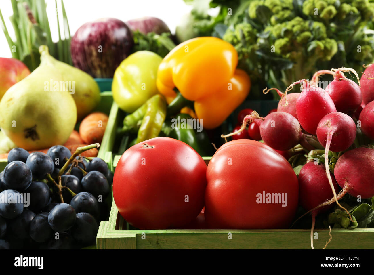 Fresh organic vegetables and fruits in wooden boxes, close up Stock ...