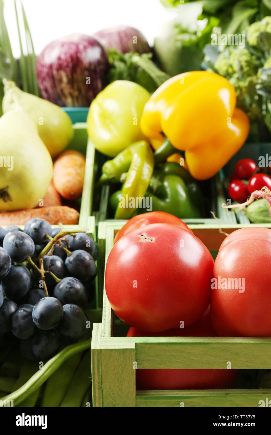 Fresh organic vegetables and fruits in wooden boxes, close up Stock ...