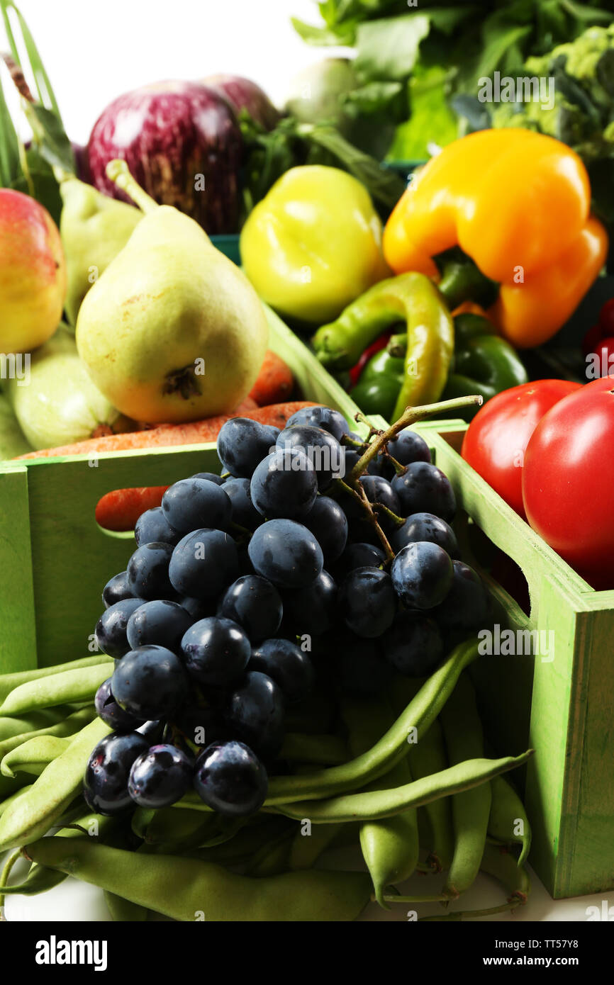Fresh organic vegetables and fruits in wooden boxes, close up Stock ...