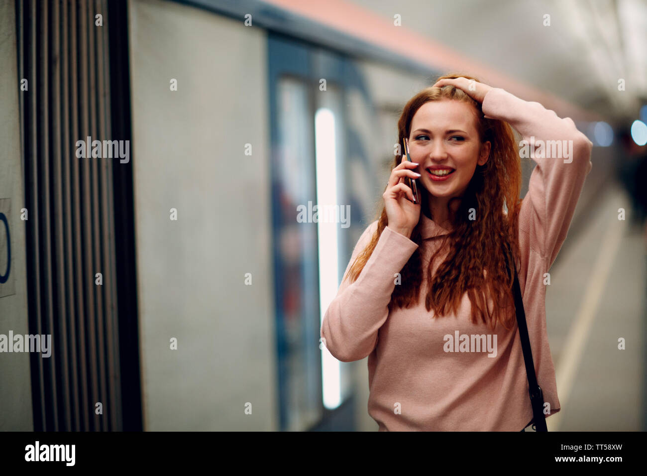 Positive redhead young female portrait. Moscow metro. Stock Photo