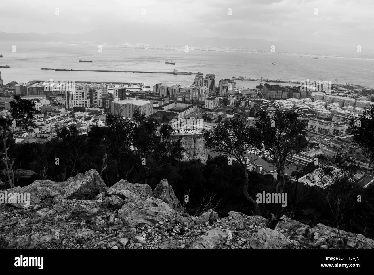 Gibraltar from the Rock water sea boat boats offices town City mountain trees harbour entrance Morocco weather landscape view views trees Stock Photo
