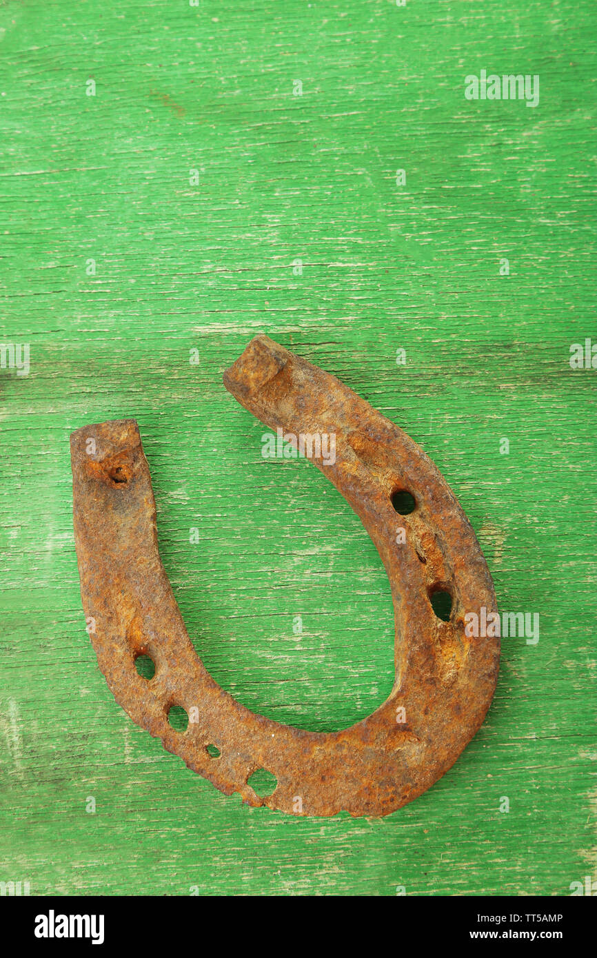 Old horse shoe on wooden background Stock Photo - Alamy