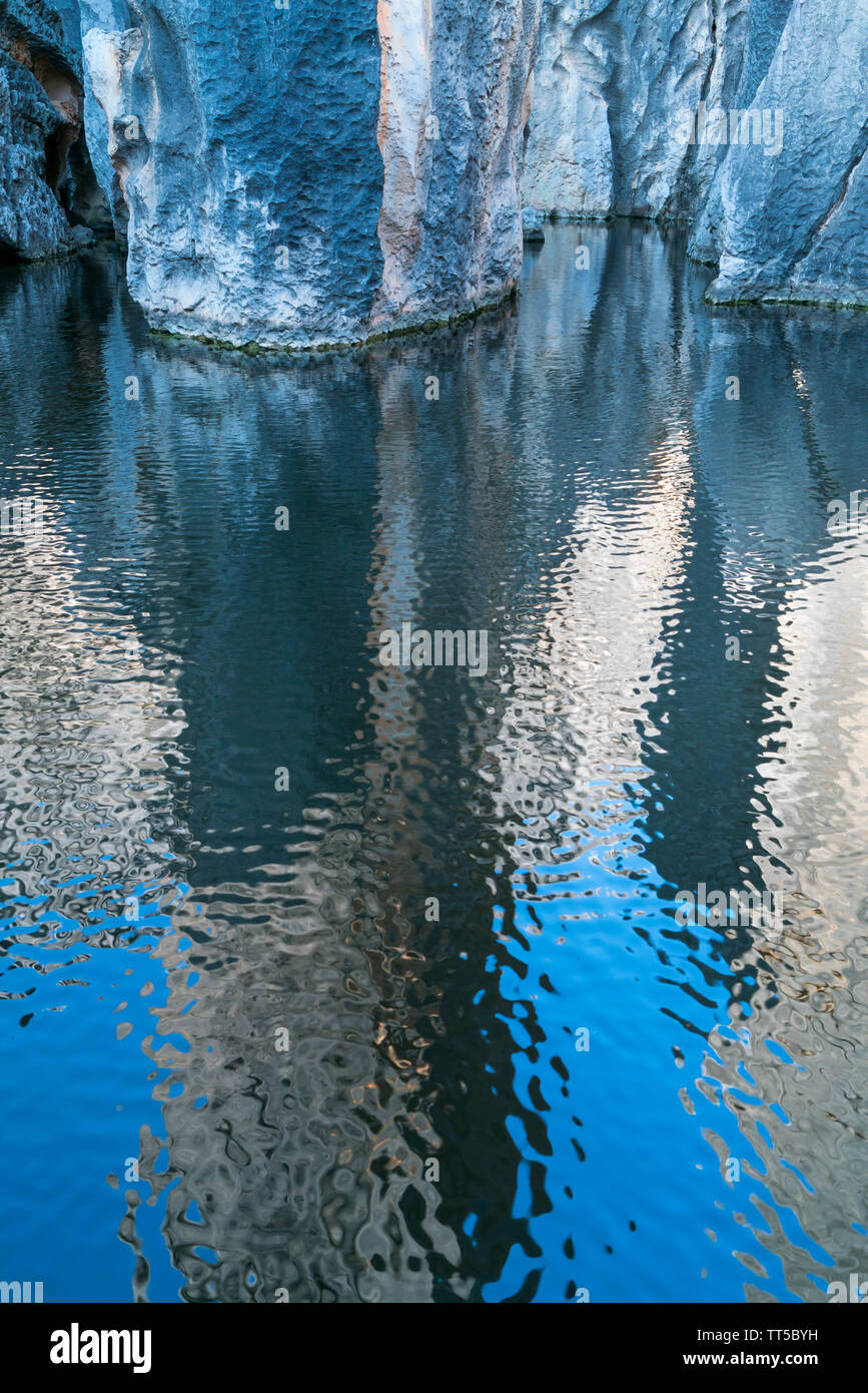 Reflection on water of tall rocks formations of limestone, The Stone ...