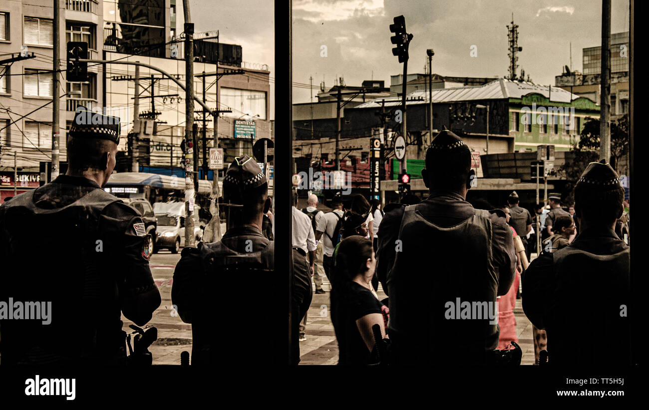 Guardians of the Streets: Vigilant Police Officers Observing Bustling City Stock Photo