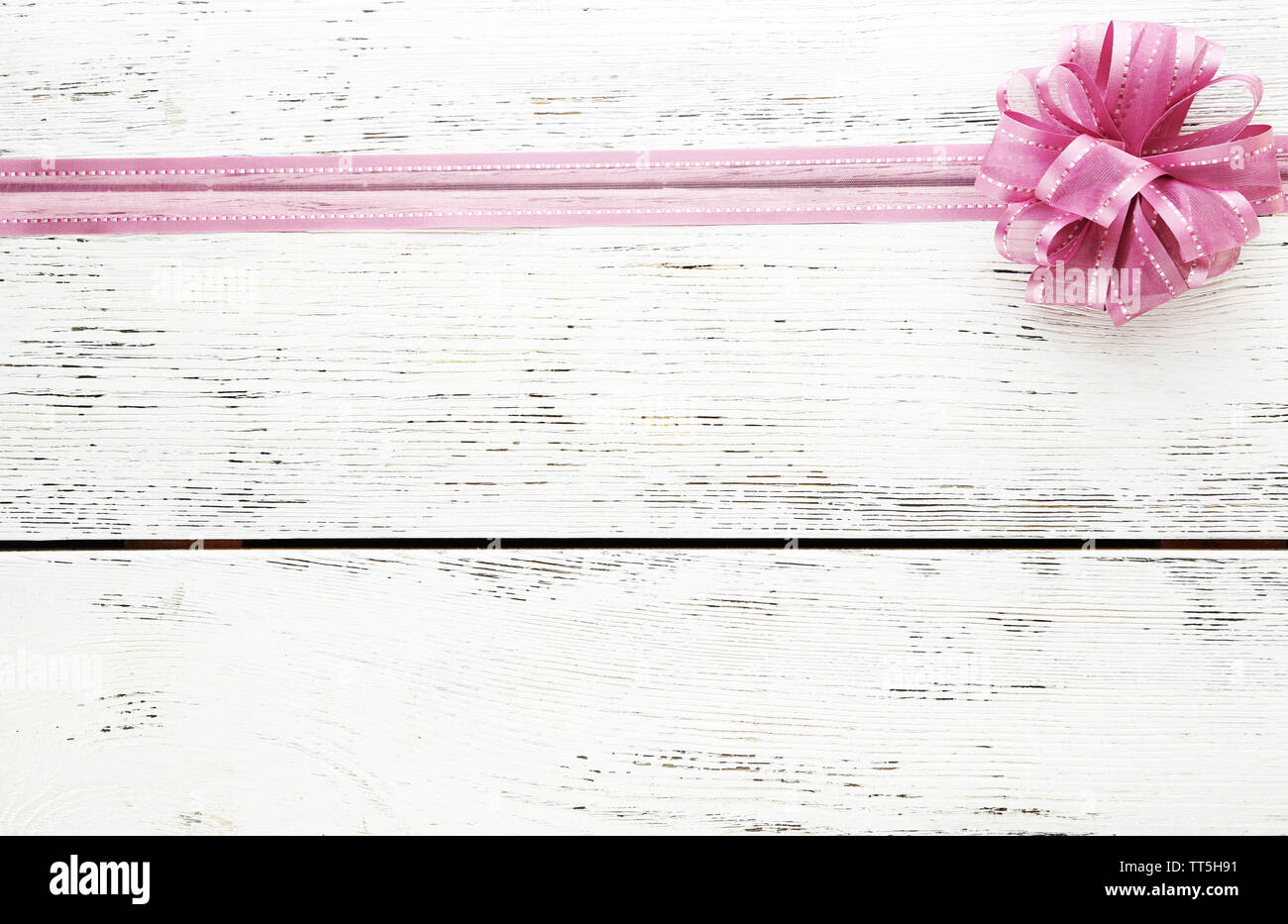 Old wooden background with beautiful bow Stock Photo - Alamy