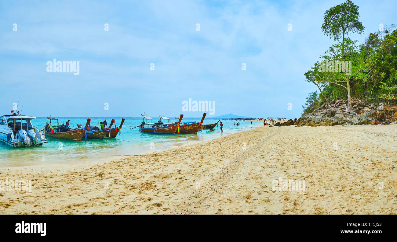 AO NANG, THAILAND - APRIL 27, 2019: Panorama of Ko Mai Phai (Bamboo Island) beachline with a view on moored longtail boats, waiting the holidaymakers, Stock Photo