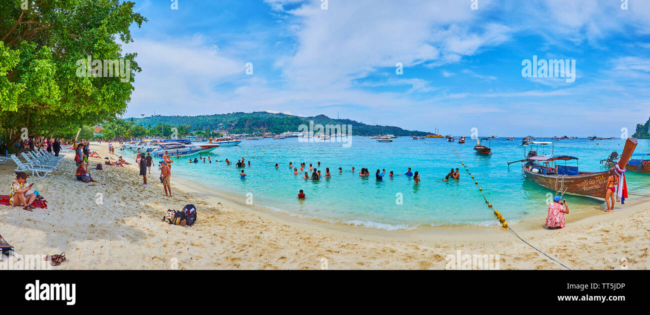 PHIPHI DON, THAILAND - APRIL 27, 2019: The numerous holidaymakers from Krabi and Phuket visit beaches of Phi Phi Don Island every day on the different Stock Photo
