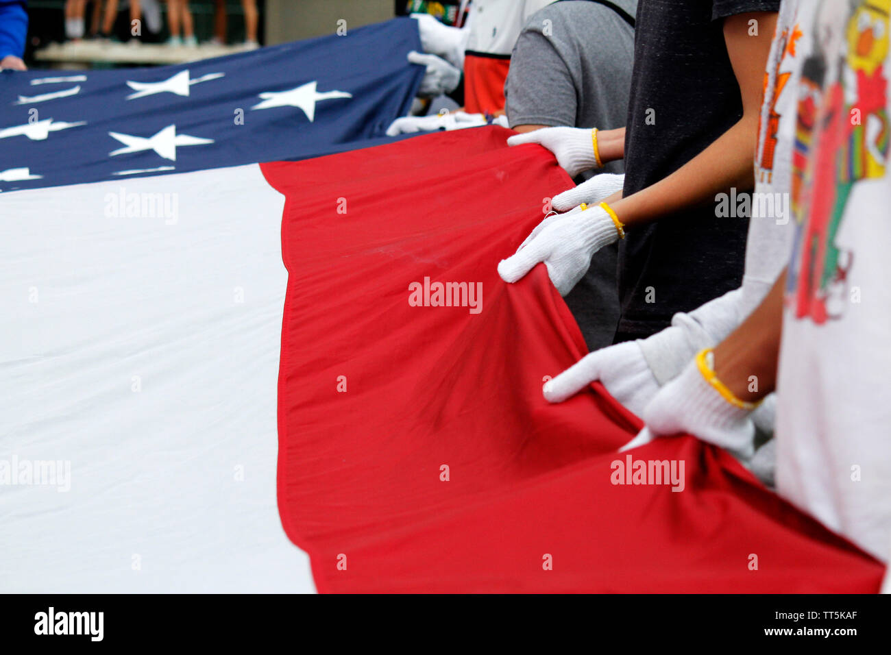 Philadelphia, PA, USA - June 14, 2019: Students work together to fold a giant American flag during Flag Day ceremonies at the National Constitution Center in Philadelphia, Pennsylvania. Credit: OOgImages/Alamy Live News Stock Photo