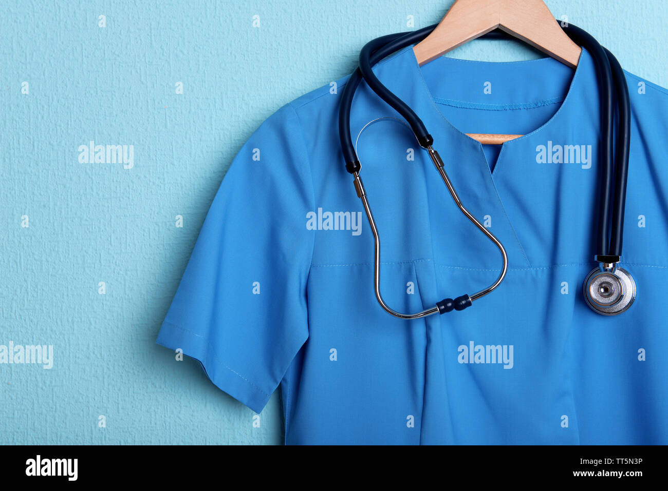 Doctor shirt with stethoscope on hanger on blue background Stock Photo ...