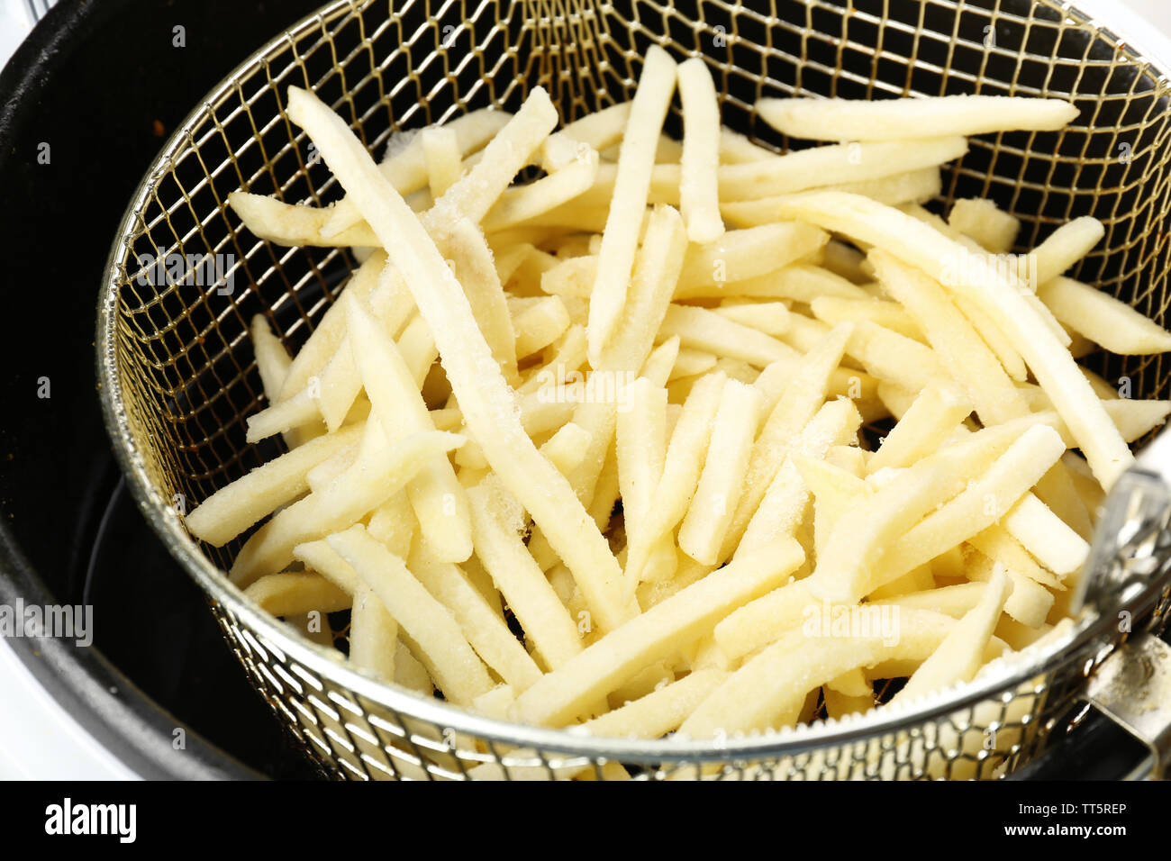French fries in deep fryer, closeup Stock Photo Alamy